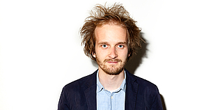Profilbild Florian Dohmann vor weißer Wand
